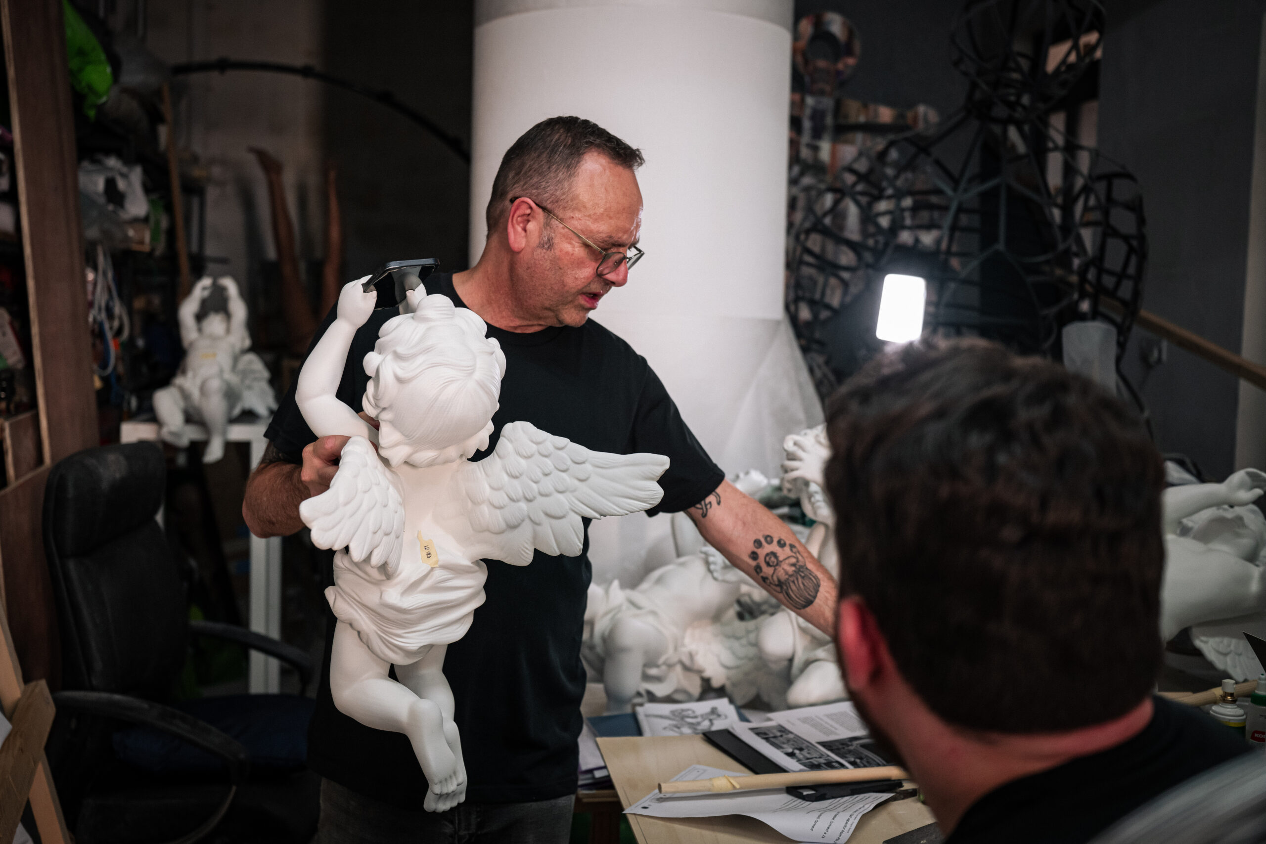 Documentary portrait of artist Pierre Portelli handling restored archival papers